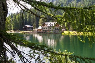 Fototapeta na wymiar Shelter in high mountain with lake