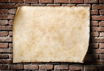 old parchment on aged brickwall