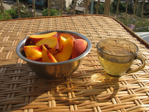 Cup of Green Tea and plate with Peach Slices
