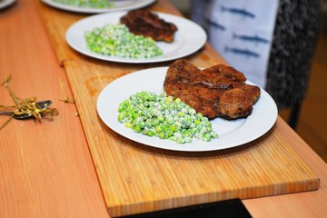 Green peas and meat on a plate