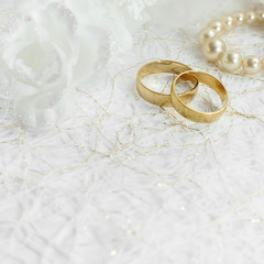 Obraz na płótnie Canvas Two golden wedding rings with seamless flower decorations