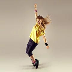 Gordijnen Zumba dance workout. Young sporty woman dancer in motion. © Stasique