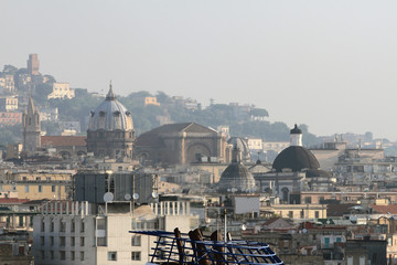 Soaring pipes of motor ship and temples in city. Naples, Italy