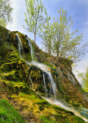Fototapeta na wymiar Small waterfall on a summer day