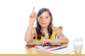 a little girl raises his hand to school