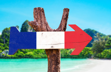 France Flag wooden sign with beach background