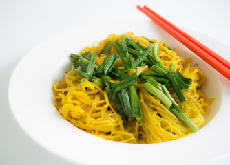 Fried noodle with red chopstick in white plate