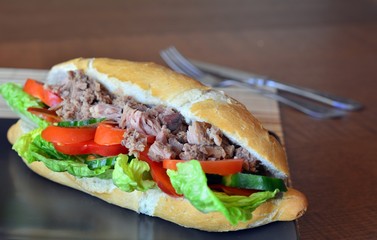 Tuna Baguette With Vegetables On The Brown Plate