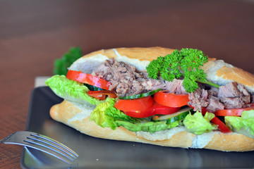 Tuna Baguette With Vegetables On The Brown Plate