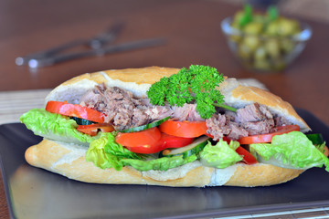 Tuna Baguette With Vegetables On The Brown Plate