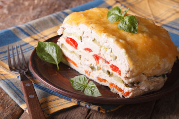 Baked chicken with vegetables and cheese on a plate, horizontal