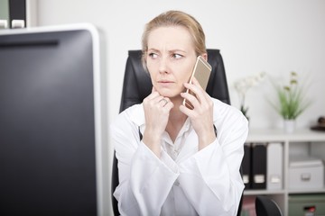 Serious Female Doctor on Phone and Looking to Left