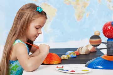 Painting the sun - schoolgirl in science class © Ilike