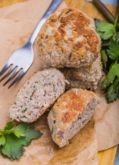 Meatballs with parsley on the kitchen board. Selective focus