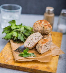 Meatballs with parsley on the kitchen board. Selective focus
