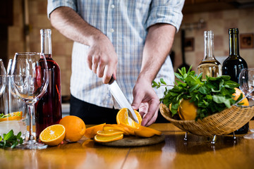 Man cuts oranges