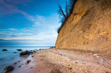 Cliff on sea shore at sunrise. Baltic sea long exposure photo