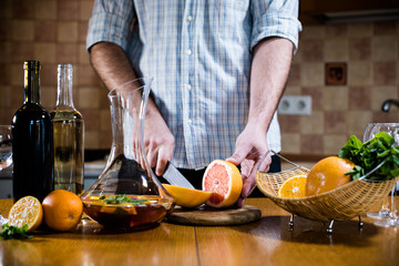 Man cuts fresh grapefruits