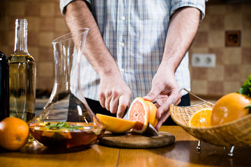 Man cuts fresh grapefruits