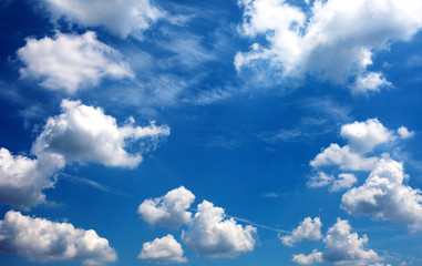 white cumulus clouds in the blue sky