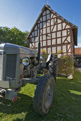 tractor old in front of a half timbered house