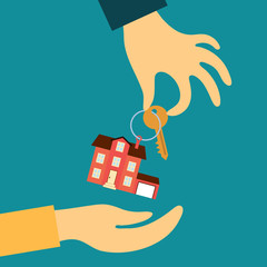 hand real estate agent holding transmits a key with a tag in the