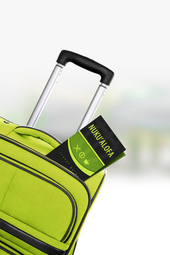 Nuku Alofa. Green Suitcase With Guidebook.