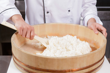 Sushi chef cooks rice