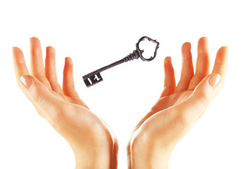 Female hands with key isolated on white