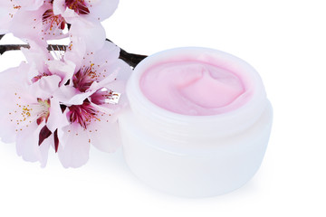 Obraz na płótnie Canvas Cosmetic cream with cherry blossoms isolated