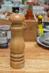 Obraz na płótnie Canvas A Wooden Pepper grinder on Local Thailand breakfast table