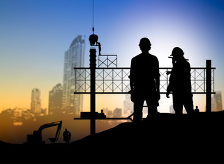 Fototapeta na wymiar silhouette engineer looking blueprint in a building site over Bl
