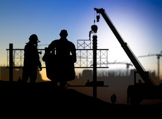 Fototapeta na wymiar silhouette engineer looking construction worker in a building si