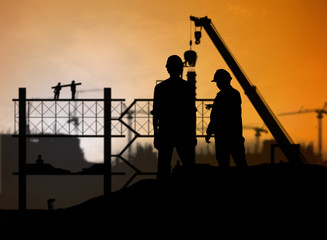 Fototapeta na wymiar silhouette engineer looking construction worker in a building si