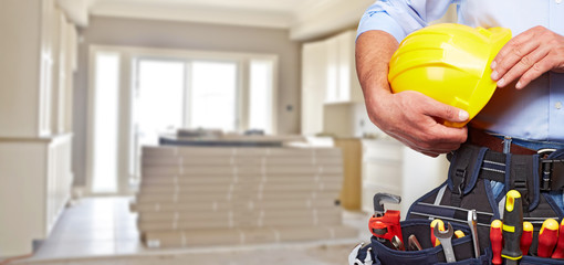 Builder handyman with construction tools.