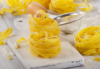 Pasta   on  a  white wooden cutting board
