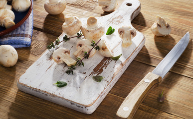 Fresh white mushrooms  on  wooden cutting board.
