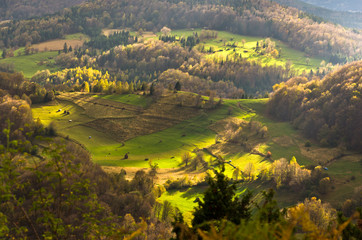 Mountain meadows at autumn illuminated by devine light