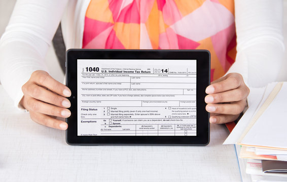 Business official showing income tax form 1040 in a tablet compu