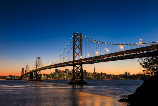 San Francisco skyline and Bay Bridge at sunset, California