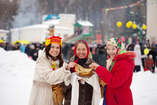 Women  tasting pancake  during  Shrovetide