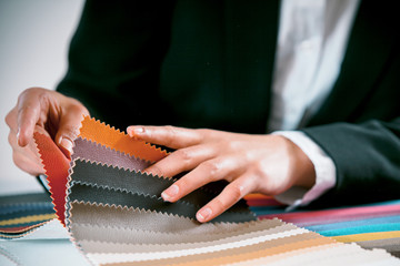 Woman checking fabric color swatches