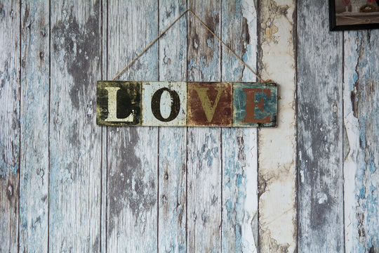 A sign with the word love on the background of old wall from boa