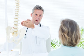 Doctor showing his patient a spine model
