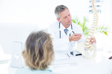 Doctor showing spine model to his patient