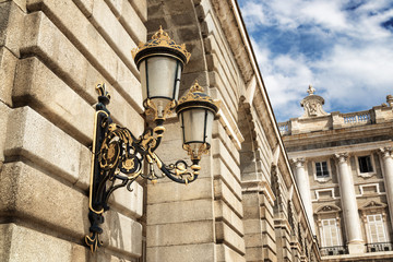 Fototapeta na wymiar Traditional forged street lamp on a wall of the Royal Palace of