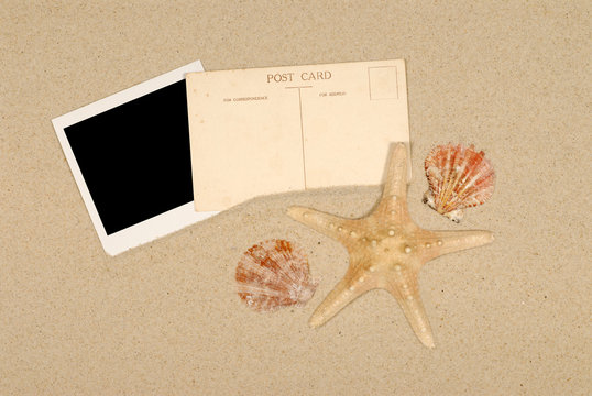 Old vintage retro postcard post card on a summer vacation tropical holiday beach with one single polaroid style photo frame print starfish and seashell