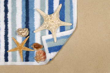 Seashore background with starfish and towel
