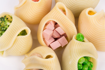 Pasta shells stuffed with vegetables and sausage.