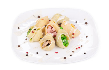 Pasta shells stuffed with vegetables and sausage.